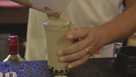 Close-up-shot-of-bartender-making-chocolate-shake-with-pearls