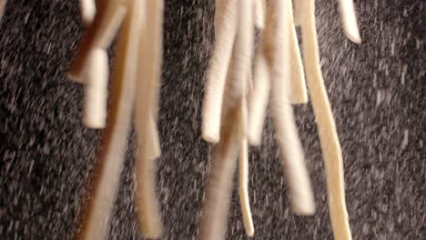A-chef-holds-strands-of-raw-pasta