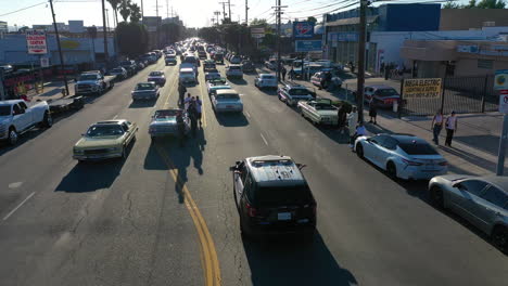 Aerial-view-following-the-police-watching-low-riders-on-the-streets-of-LA,-USA