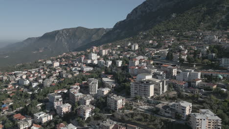 Droneshot-from-above-Kruja-Albania-flying-over-the-town-on-the-cliff-on-a-cloudy-day-with-clouds-against-the-mountains-LOG