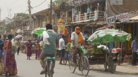 Midday-heat-wave-and-strong-wind-in-summer-in-rural-town-of-northern-India,-Busy-and-crowded-street,-Asia