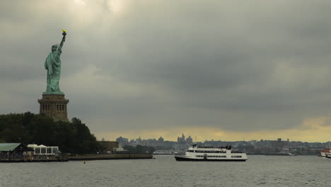 Statue-of-Liberty-on-Pedestal-in-NYC-Harbor-with-Ferry-Arriving