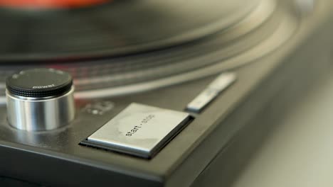 Finger-starts-and-stops-vinyl-record-on-retro-LP-player--Music-starts-playing