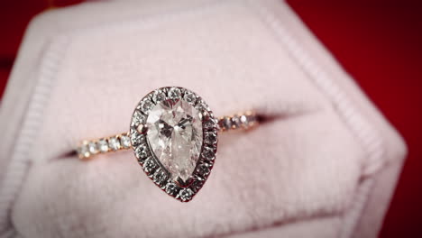 MACRO-Diamond-Encrusted-Engagement-Ring-Against-A-Red-Background