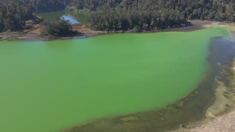Tranquil-aerial-view-of-mirror-like-emerald-green-lake
