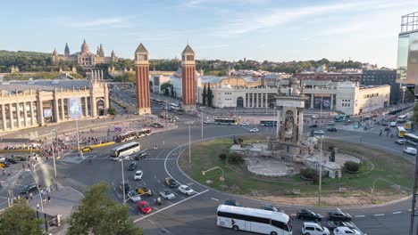 Time-Lapse-of-Plaça-d'Espanya-Roundabout-in-Barcelona,-Elevated-View-Featuring-the-National-Palace,-Busy-Traffic,-Cityscape,-Dusk-to-Dawn