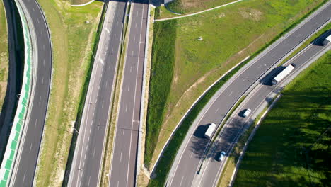Aerial-top-down-shot-of-traffic-on-highway-and-road-junction-with-bridges-at-sunny-day-in-Poland