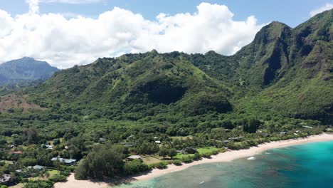 Reverse-panning-aerial-shot-of-pristine-Haena-Beach-on-the-island-of-Kaua'i-in-Hawai'i