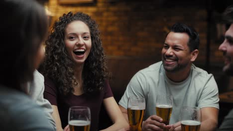 Mid-shot-video-of-group-of-friends-spending-time-in-the-pub