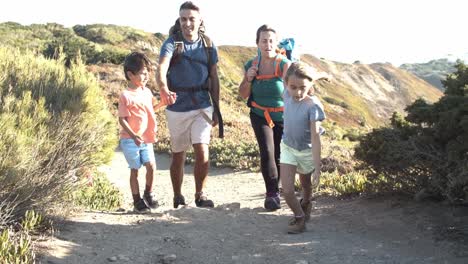 Active-parents-and-kids-walking-on-path-downhill