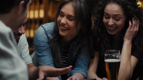 Handheld-video-of-friends-meeting-in-the-pub-and-having-fun-while-using-phone