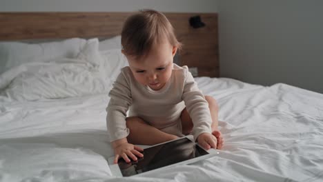 Video-of-caucasian-little-girl-using-digital-tablet-at-home.