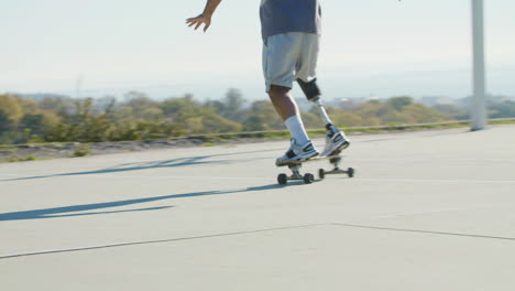 Energetic-middle-aged-man-with-leg-prosthesis-skateboarding