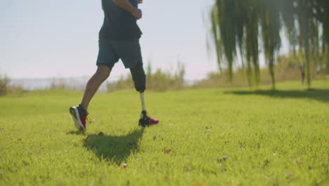 Closeup-of-athlete-with-prosthetic-leg-jogging-at-river-bank