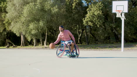 Strong-man-in-sports-wheelchair-playing-basketball