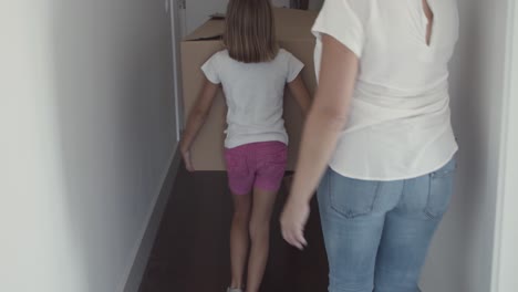Family-couple-and-two-girls-leaving-apartment