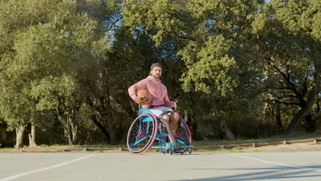 Young-bearded-man-in-sports-wheelchair-at-basketball-court