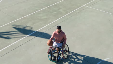 Middle-aged-man-in-sport-wheelchair-enjoying-streetball-game