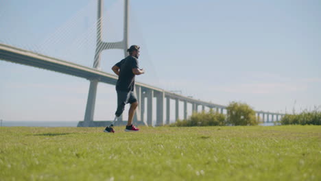 Tracking-shot-of-athlete-with-prosthetic-leg-jogging-in-park.