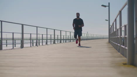 Male-athlete-with-artificial-leg-jogging-on-bridge.