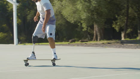 Active-middle-aged-guy-with-leg-prosthesis-skateboarding
