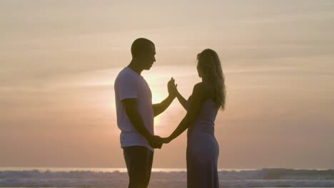 Beautiful-Caucasian-couple-holding-hands-at-seashore.