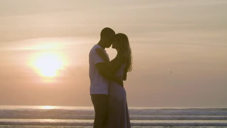 Romantisches-Kaukasisches-Paar,-Das-Sich-Vor-Dem-Hintergrund-Des-Sonnenuntergangs-Küsst.