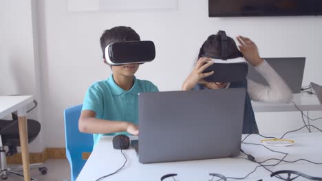 Two-classmates-putting-on-VR-goggles