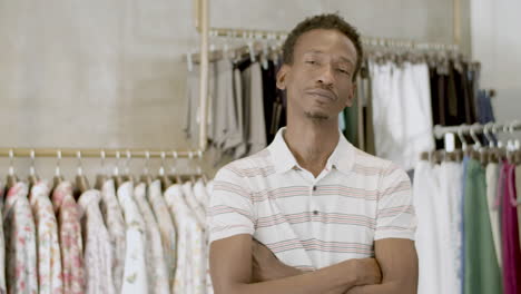 Bearded-black-man-standing-with-folded-arms-in-clothing-store.