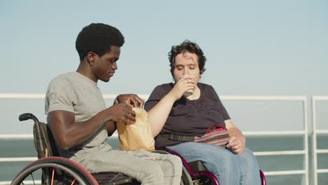 Happy-couple-with-disability-drinking-coffee-and-having-snack