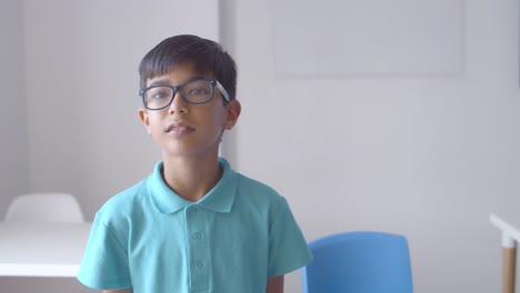 Cheerful-Latin-school-boy-wearing-glasses