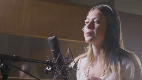Beautiful-female-singer-working-in-music-studio