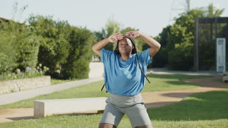 Front-view-of-African-American-woman-doing-jumping-jacks