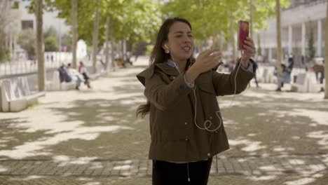 Smiling-young-woman-having-video-call-through-smartphone.