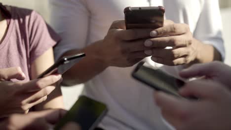 Closeup-shot-of-young-people-with-smartphones-on-street