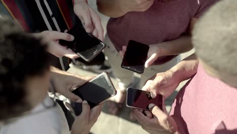 Top-view-of-young-people-using-smartphones.