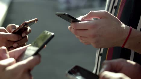 Closeup-view-of-young-people-using-smartphones.