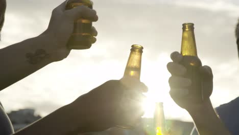 Smiling-young-men-dancing-with-beer-bottles