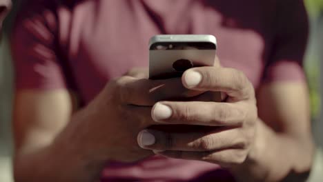 Closeup-shot-of-male-hands-typing-message-on-smartphone.