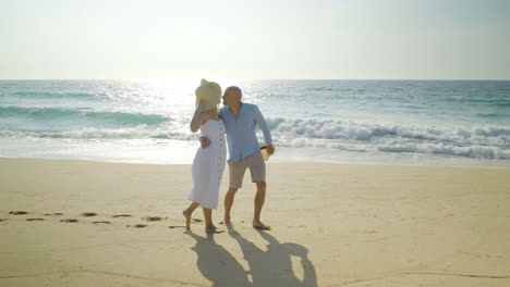 Couple-in-love-walking-together-on-beach