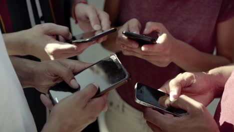 Cropped-shot-of-young-people-using-smartphones.
