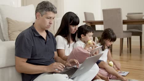 Focused-parents-couple-using-computers
