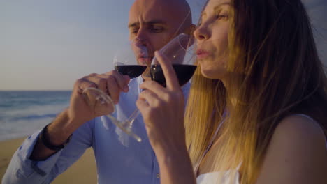 Couple-drinking-red-wine-and-looking-at-sea