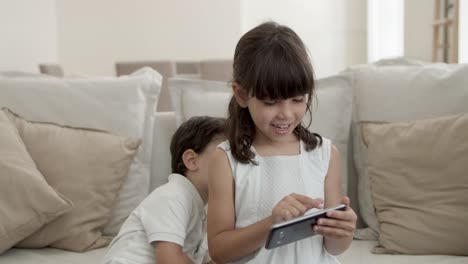 Sweet-little-kids-using-phone-for-video-talk
