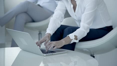 Cropped-shot-of-businesswoman-using-laptop