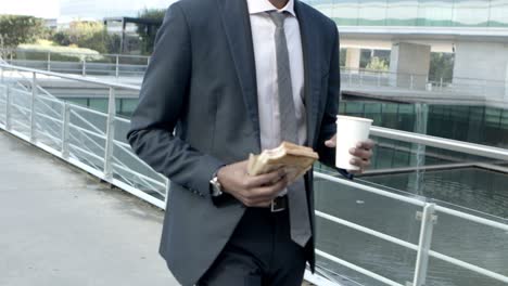 Businessman-with-sandwich-and-coffee-to-go