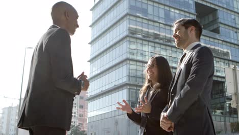 Cheerful-business-people-shaking-hands-outdoors
