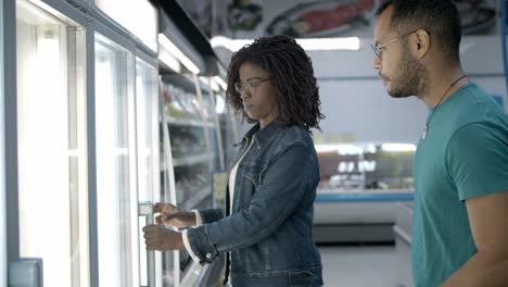 Smiling-African-American-couple-buying-food-at-grocery-store