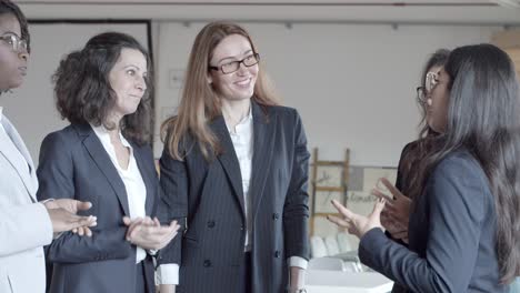 Cheerful-businesswomen-talking-in-office