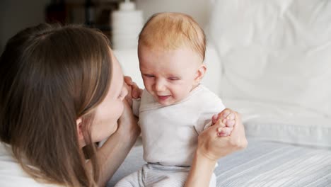 Joyful-mom-communicating-with-adorable-baby-daughter
